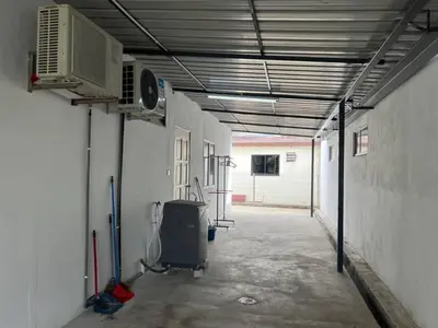 an empty hallway of a garage with a air conditioner at Vintage Comfort 3Bedroom Haus in Lunas