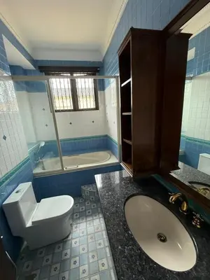 a blue and white bathroom with a toilet and a sink at Majestic Bungalow Seberang Jaya in Perai