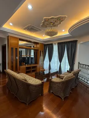 a living room with wicker chairs and a television at Majestic Bungalow Seberang Jaya in Perai