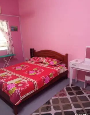 a bedroom with a red bed and a white desk at Homestay Bajet IPOH in Ipoh