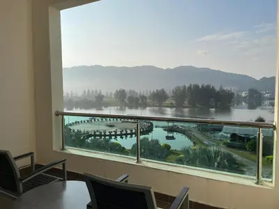 a room with a large window with a view of a lake at Homestay Marina in Lumut