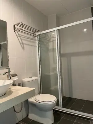 a bathroom with a shower and a toilet and a sink at Homestay Marina in Lumut