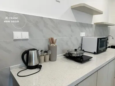a kitchen counter with a coffee maker and a microwave at Family Suites Netflix House Aston Acacia Bukit Mertajam in Bukit Mertajam