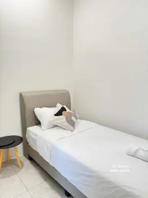 a bedroom with a bed with a bird on the pillow at Family Suites Netflix House Aston Acacia Bukit Mertajam in Bukit Mertajam