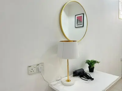a table with a mirror and a lamp on it at Life Art Home Family Ipoh Homestay 5R4B 18pax SY28 in Ipoh