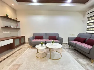 a living room with two couches and a table at Life Art Home Family Ipoh Homestay 5R4B 18pax SY28 in Ipoh