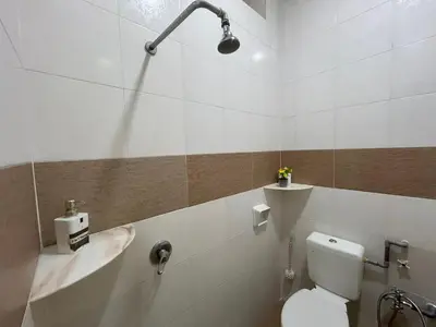 a white bathroom with a toilet and a sink at Life Art Home Family Ipoh Homestay 5R4B 18pax SY28 in Ipoh