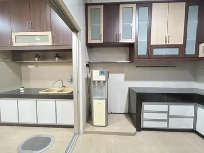 a kitchen with wooden cabinets and a refrigerator at Life Art Home Family Ipoh Homestay 5R4B 18pax SY28 in Ipoh