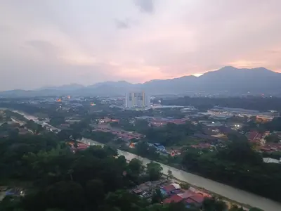 a view of a city with a river and mountains at Airra Minimalist Suite-Ipoh Town in Ipoh