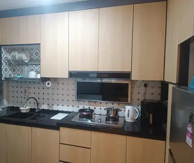 a kitchen with a stove and a microwave at Airra Minimalist Suite-Ipoh Town in Ipoh