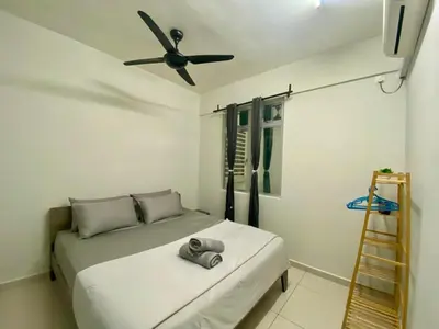 a bedroom with a bed and a ceiling fan at Airra Minimalist Suite-Ipoh Town in Ipoh
