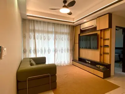 a living room with a couch and a television at Airra Minimalist Suite-Ipoh Town in Ipoh