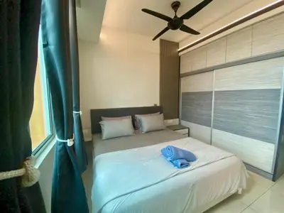 a bedroom with a white bed with a ceiling fan at Airra Minimalist Suite-Ipoh Town in Ipoh