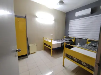 a room with two bunk beds and a door at Firza Suite in Gua Sai