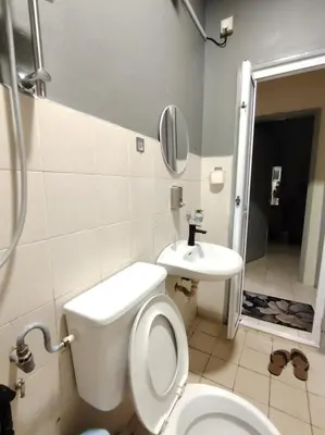 a bathroom with a toilet and a sink at Firza Suite in Gua Sai