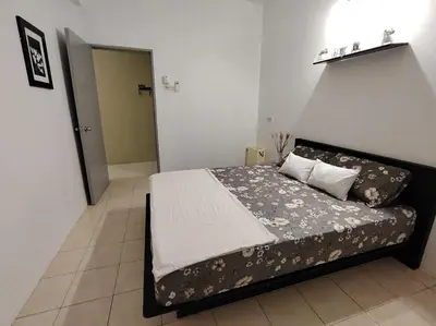 a bedroom with a bed in a room at Firza Suite in Gua Sai