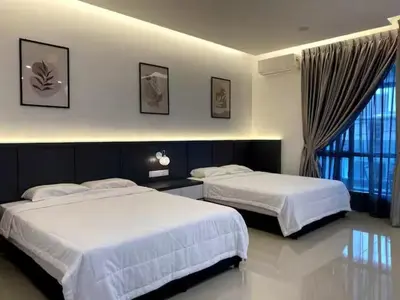a bedroom with two beds and a window at 38G Homestay in Teluk Intan