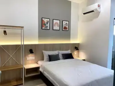 a bedroom with a large white bed in a room at 38G Homestay in Teluk Intan