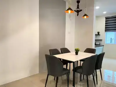 a dining room with a table and chairs at 38G Homestay in Teluk Intan