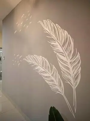 a wall with a feather stencil on a wall at Nordic Haven \u5317\u6b27\u6696\u5c45 in Taiping