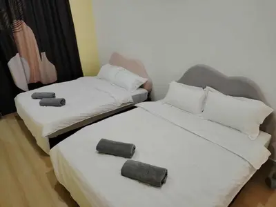 two beds sitting next to each other in a room at Nordic Haven \u5317\u6b27\u6696\u5c45 in Taiping