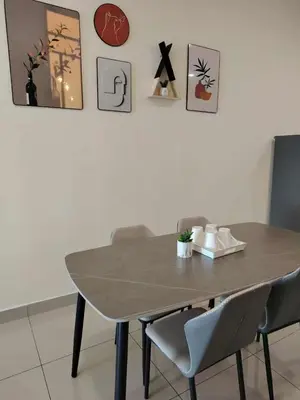 a table and chairs in a room with pictures on the wall at Nordic Haven \u5317\u6b27\u6696\u5c45 in Taiping