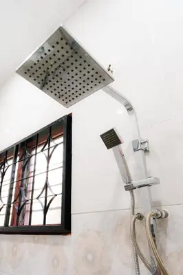 a shower head in a bathroom with a window at Villa Cinta Jasmeen in Kuala Kangsar