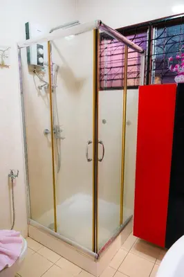 a shower with a glass door in a bathroom at Villa Cinta Jasmeen in Kuala Kangsar