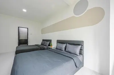 a bedroom with a large bed and white walls at Modern Comfort - 3R & 3B Brinchang Cameron Highland Clover Home 4-25 in Brinchang
