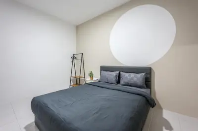 a bedroom with a large bed with a white wall at Modern Comfort - 3R & 3B Brinchang Cameron Highland Clover Home 4-25 in Brinchang