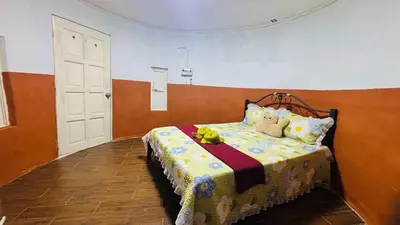 a bedroom with a bed with a bedspread and stuffed animals on it at Capital O 91187 D'dusun Raudhah Chalet in Baling