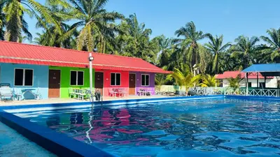 a resort with a swimming pool in front at Capital O 91191 Chalet Cd Impiana in Kulim