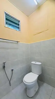 a bathroom with a white toilet and a window at Capital O 91191 Chalet Cd Impiana in Kulim