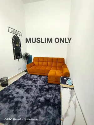 a living room with a couch and a mirror at NH Stay, Parit Buntar Perak in Parit Buntar