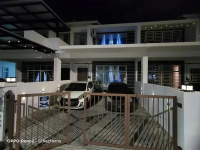 two cars parked in front of a house at night at NH Stay, Parit Buntar Perak in Parit Buntar