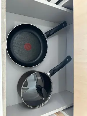 a frying pan and a mirror on a wall at Southbay Seaview Condo A31 #10minQueensbay in Bayan Lepas