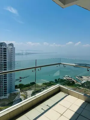 a view of the ocean from the balcony of a building at Southbay Seaview Condo A31 #10minQueensbay in Bayan Lepas