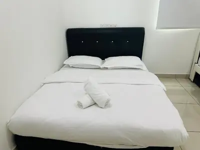 a large white bed with two pillows on it at Southbay Seaview Condo A31 #10minQueensbay in Bayan Lepas