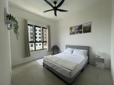 a bedroom with a bed and a ceiling fan at Aston Acacia Homestay in Bukit Mertajam