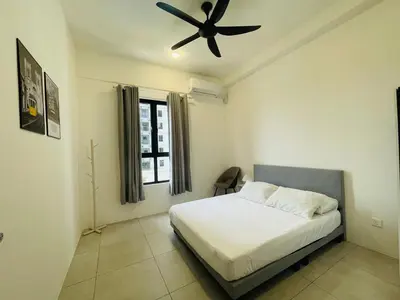 a bedroom with a bed with a ceiling fan at Aston Acacia Homestay in Bukit Mertajam