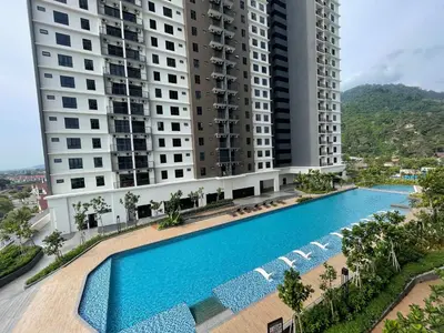 an overhead view of a swimming pool with two tall buildings at Aston Acacia Homestay in Bukit Mertajam