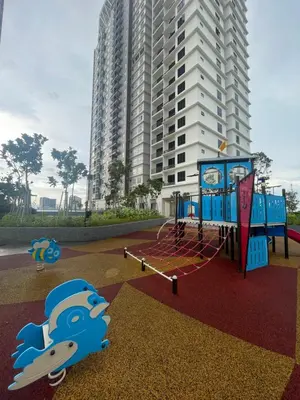 a playground in front of a tall building at Aston Acacia Homestay in Bukit Mertajam