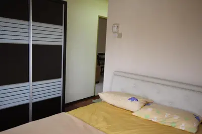 a bedroom with a bed and a mirror at Eden Seaview in Batu Ferringhi
