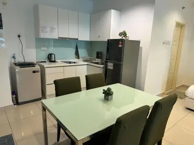 a kitchen with a table and chairs and a refrigerator at Mansion One Seaview Studio 4 pax Gurney in George Town
