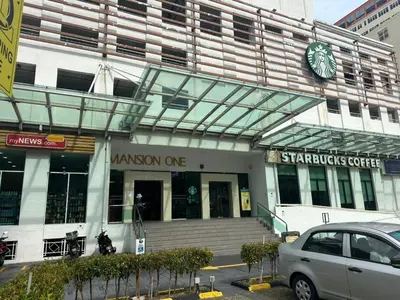 a building with a car parked in front of it at Mansion One Seaview Studio 4 pax Gurney in George Town