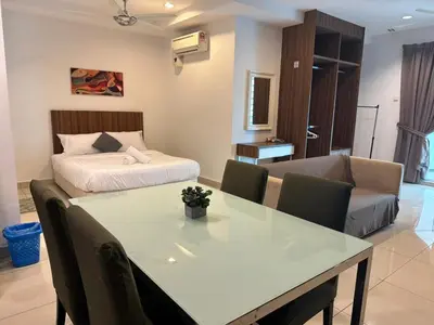 a living room with a table and a bed at Mansion One Seaview Studio 4 pax Gurney in George Town