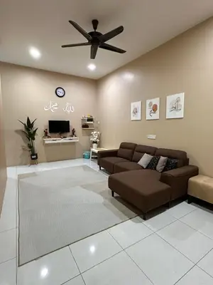 a living room with a couch and a ceiling fan at MrsSafiyya Homestay in Tanjung Rambutan