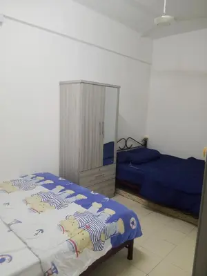 a bedroom with a bed and a cabinet in it at Little sweet homestay in Ipoh