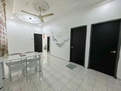 a dining room with a table and some black doors at Queen Bed Budget Room in Padang Serai