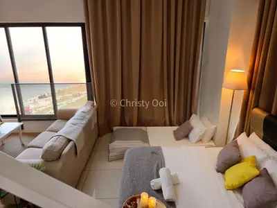 a hotel room with two beds and a large window at NEW 2BR Sunrise Gurney with Stunning Seaview \u65e0\u654c\u65e5\u51fa\u6d77\u666f\u623f in George Town